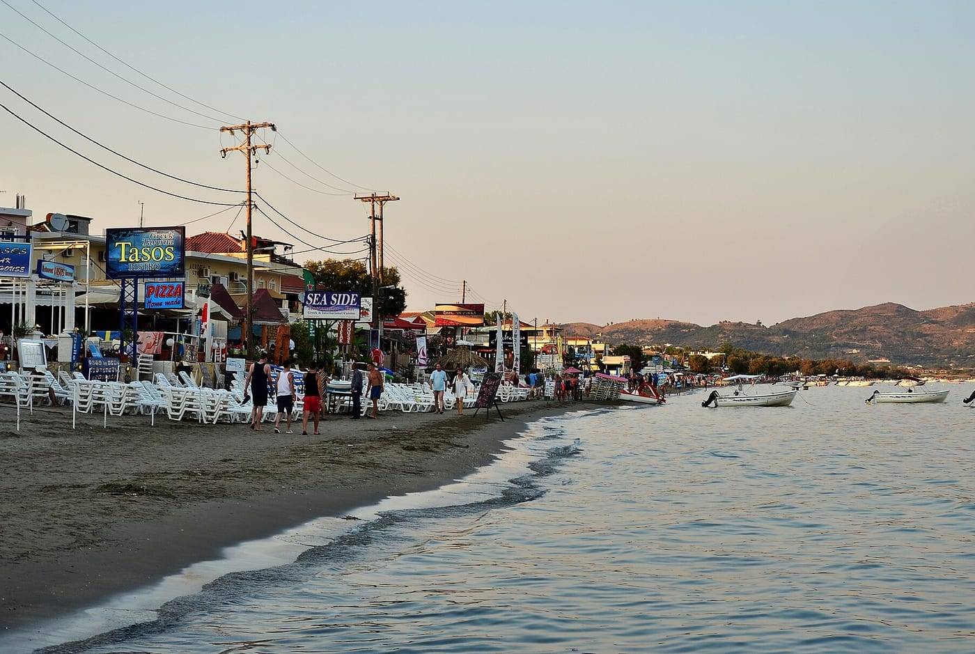 Laganas beachfront at dusk, Zante, with the beach bars and small boats
